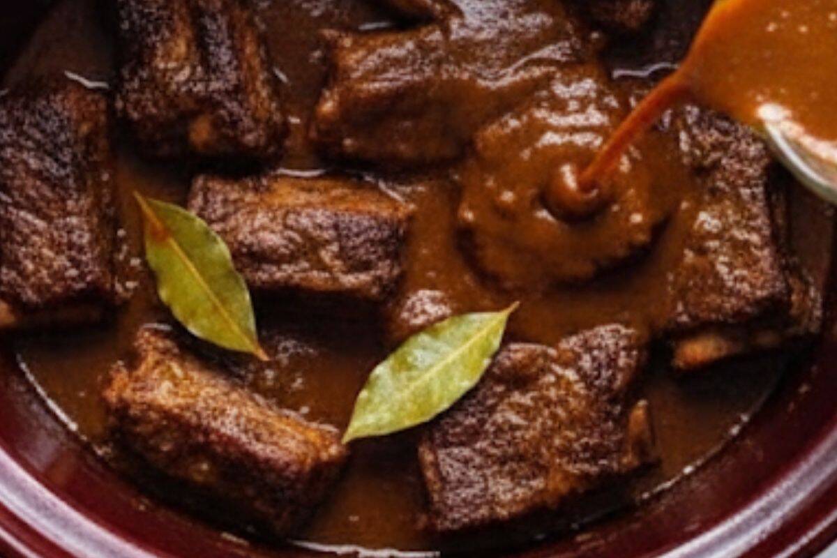 In a jug, whisk together chipotle peppers, adobo sauce, onion, garlic, barbecue sauce, lime juice, vinegar, bay leaves, cumin, salt, and beef broth until well blended.