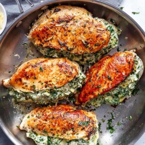 Spinach Artichoke Stuffed Chicken Breast on a pan
