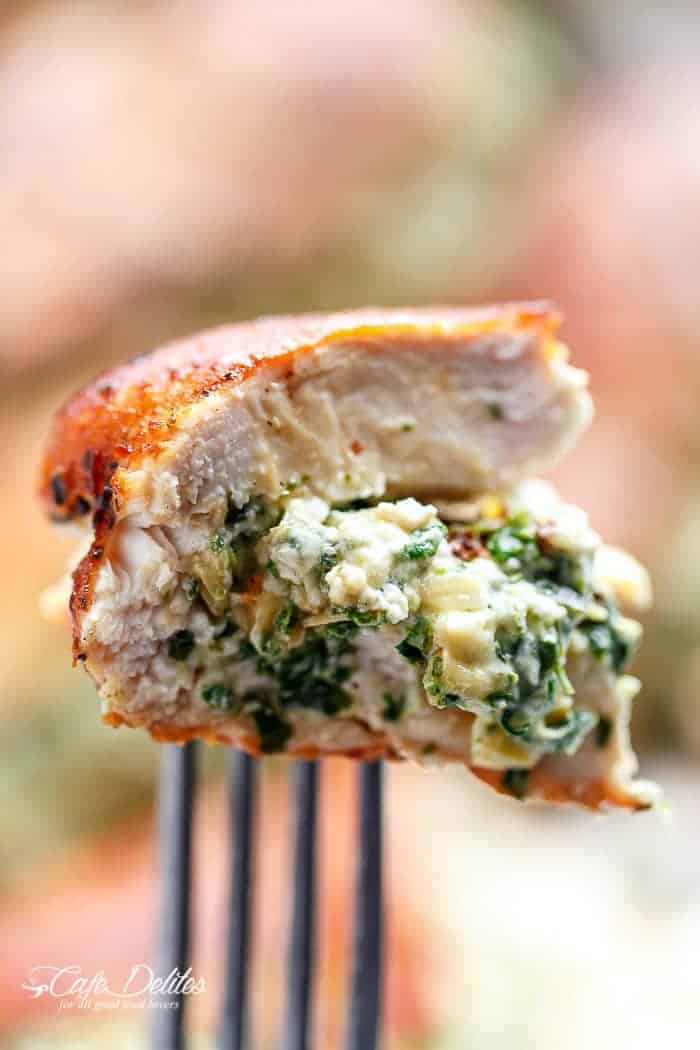 A bite Spinach Artichoke Stuffed Chicken on fork