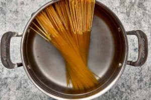 Spaghetti cooking in a pot of boiling water