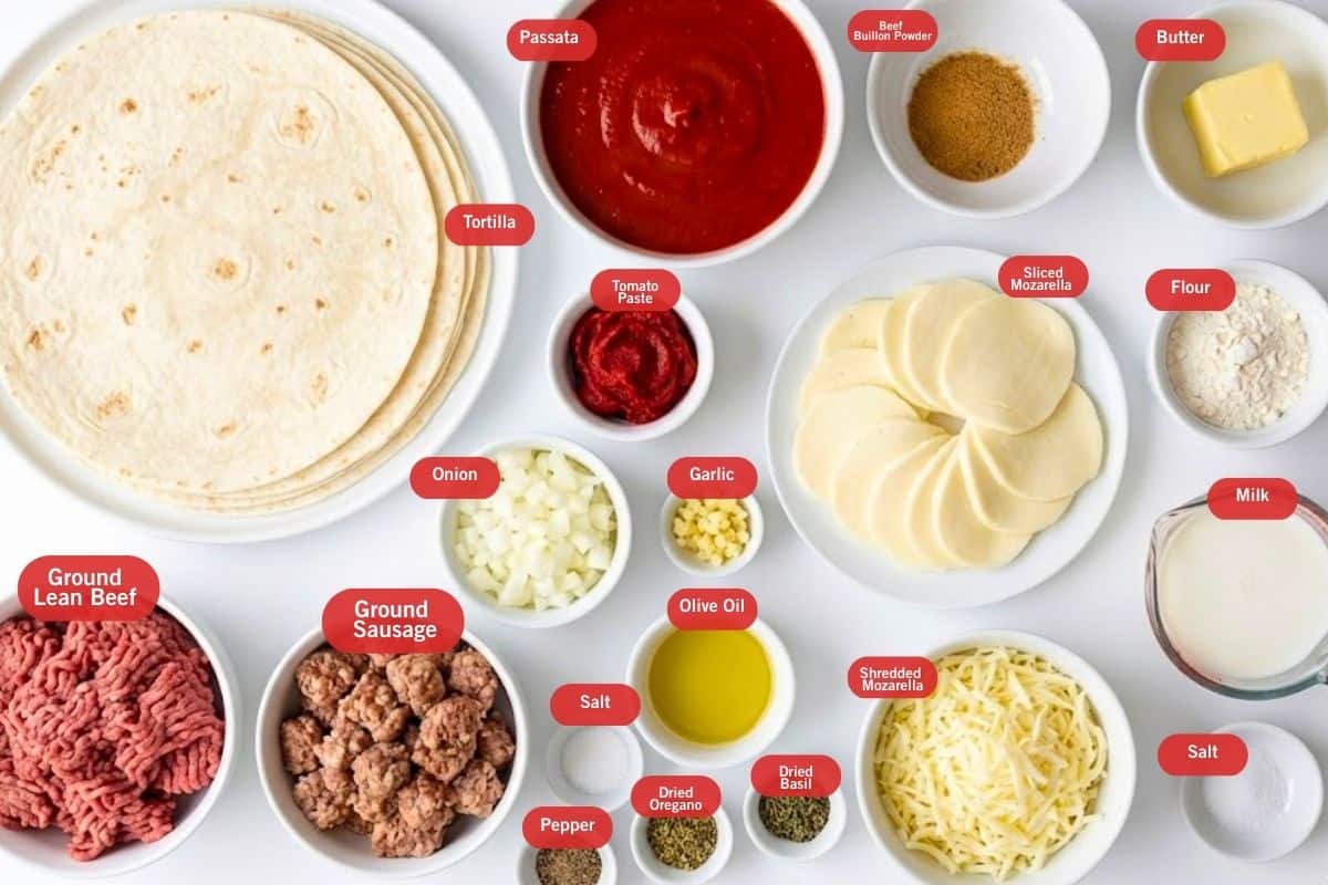 Flat lay photo of ingredient shot of tortillas, passata, beef bouillon powder. butter, flour, milk, salt, shredded mozzarella, sliced mozzarella, tomato paste, onion, garlic, olive oil, dried basil, dried oregano, pepper, salt, ground sausage, ground lean beef