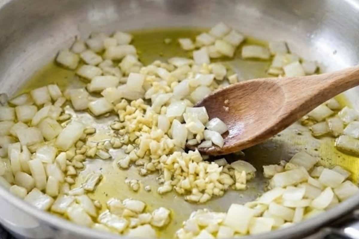 Heat the olive oil in a large pan over low to medium heat, then sauté the onion and garlic