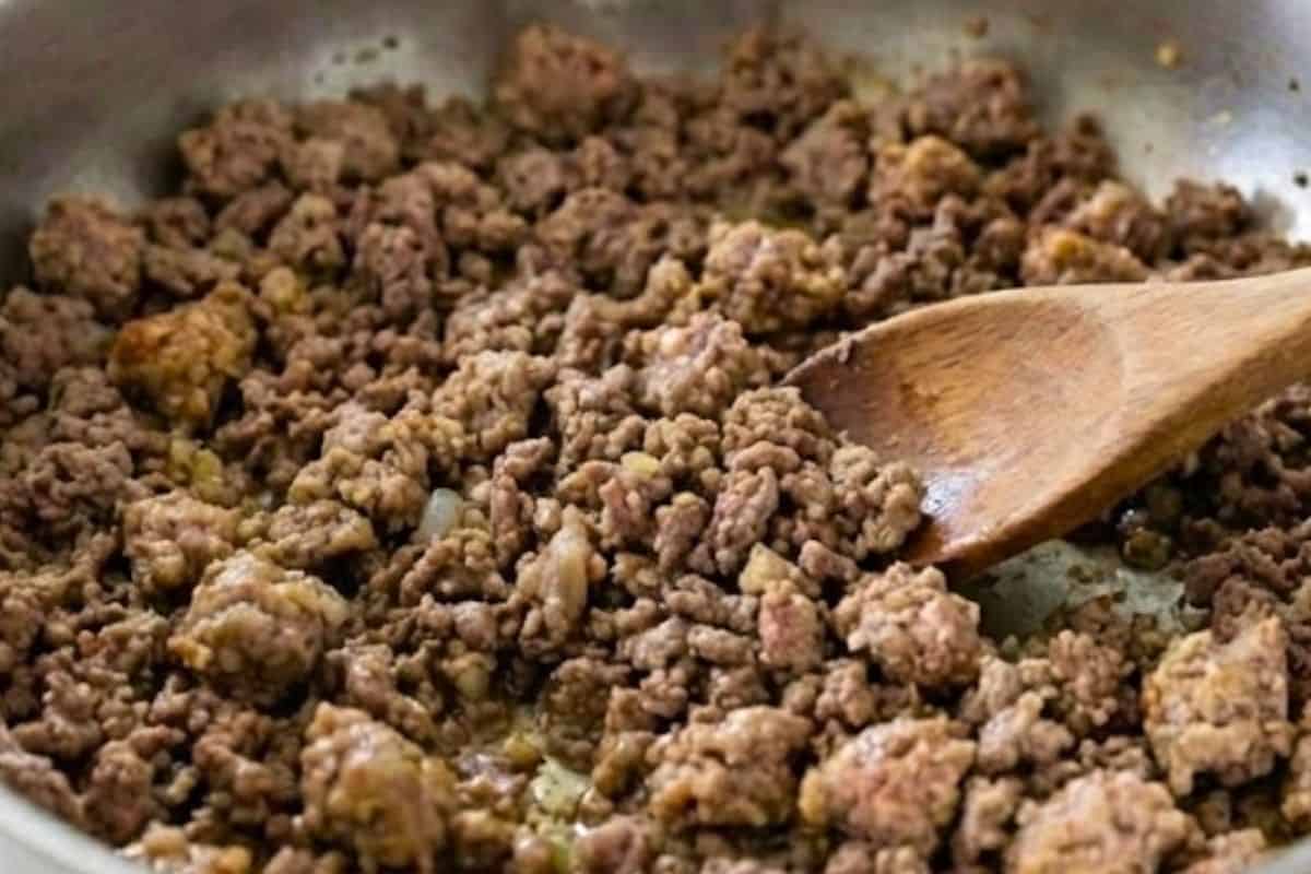 Add the ground beef and sausage, breaking it apart with a wooden spoon