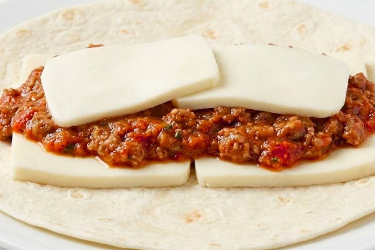 Layer mozzarella, about one quarter cup of meat sauce, and more mozzarella onto each tortilla