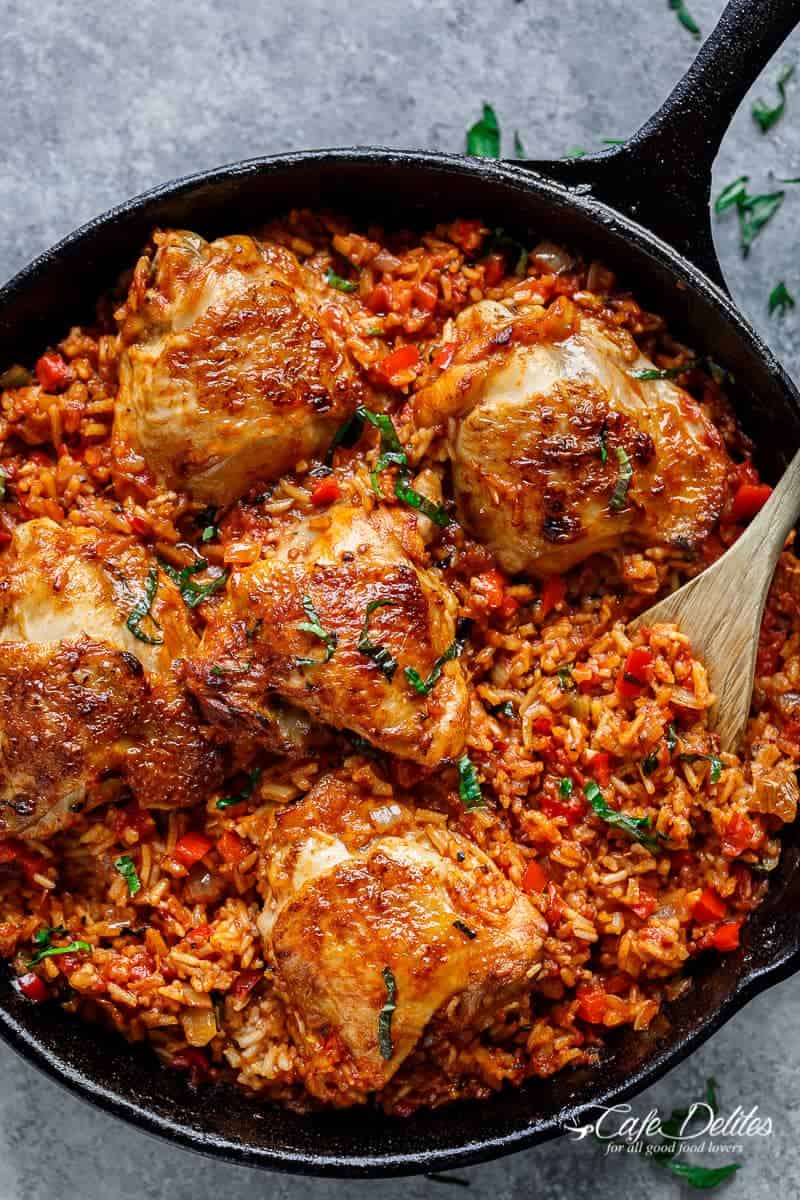 One Pan Tomato Basil Chicken & Rice with wooden spoon in a pan