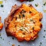 A piece of Garlic Butter Smashed Sweet Potatoes With Parmesan Cheese.