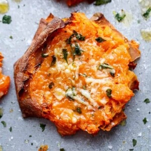 A piece of Garlic Butter Smashed Sweet Potatoes With Parmesan Cheese.