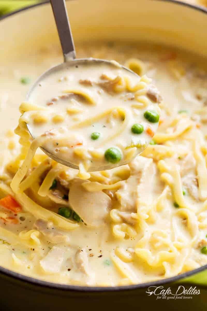 Super creamy Chicken Noodle Soup in a ladle from the bowl