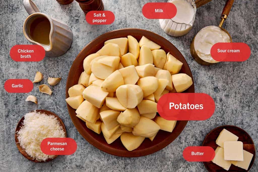 top down shot of all the ingredients to make creamy mashed potatoes on the kitchen top all in individual bowls.