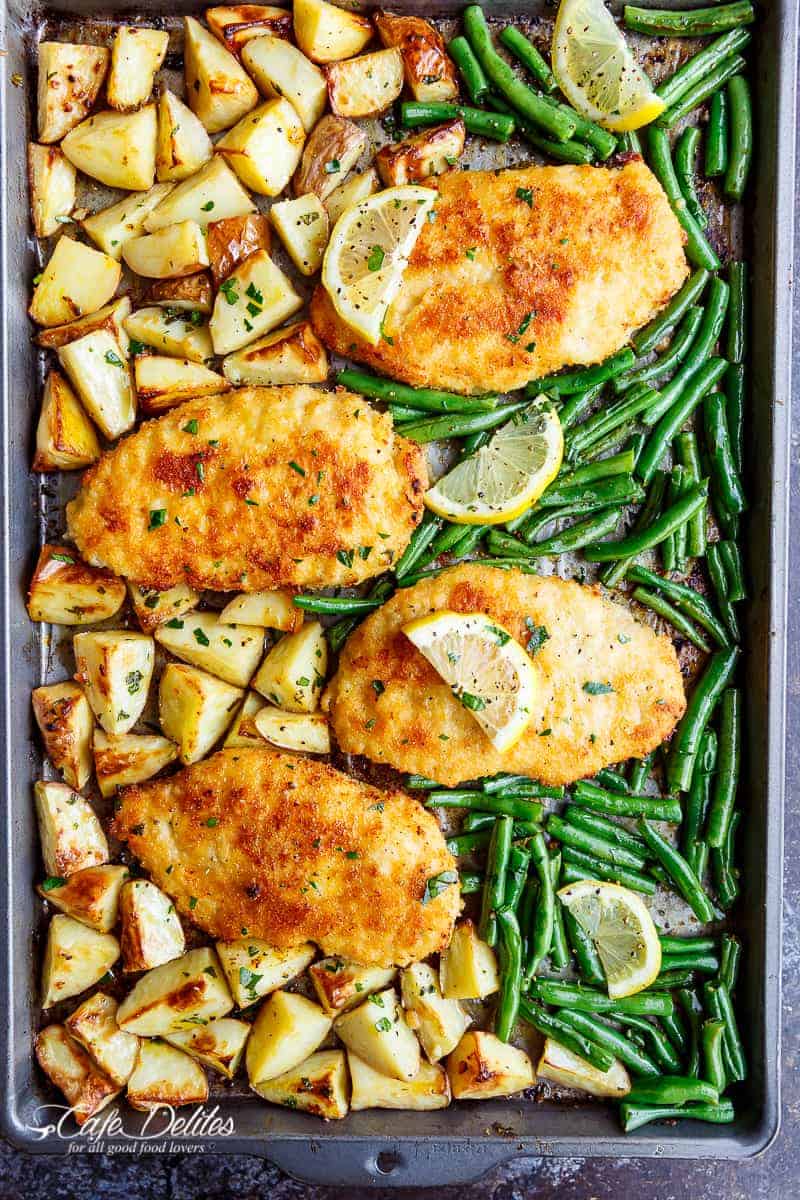 Oven baked and CRISPY breaded Sheet Pan Lemon Parmesan Garlic Chicken & Veggies, complete with potatoes and green beans smothered in a garlic butter sauce! 