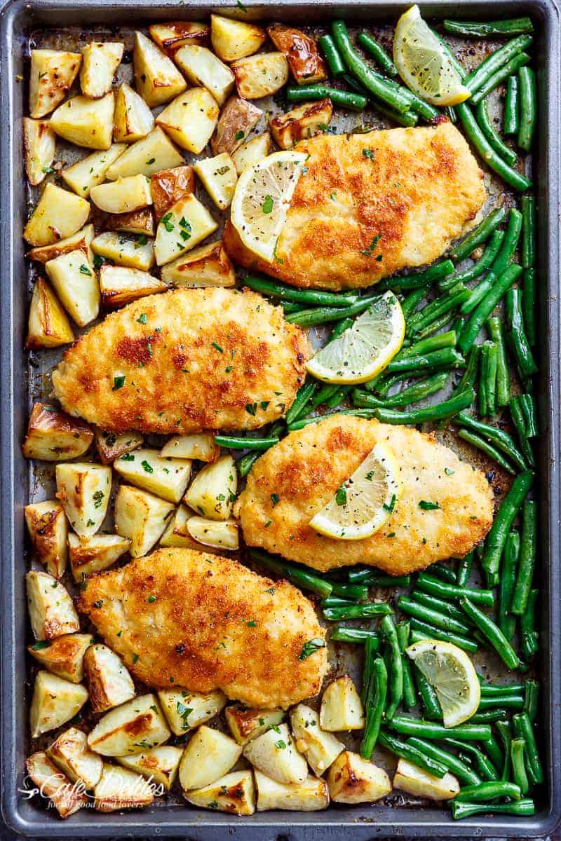 Oven baked and CRISPY breaded Sheet Pan Lemon Parmesan Garlic Chicken & Veggies, complete with potatoes and green beans smothered in a garlic butter sauce!