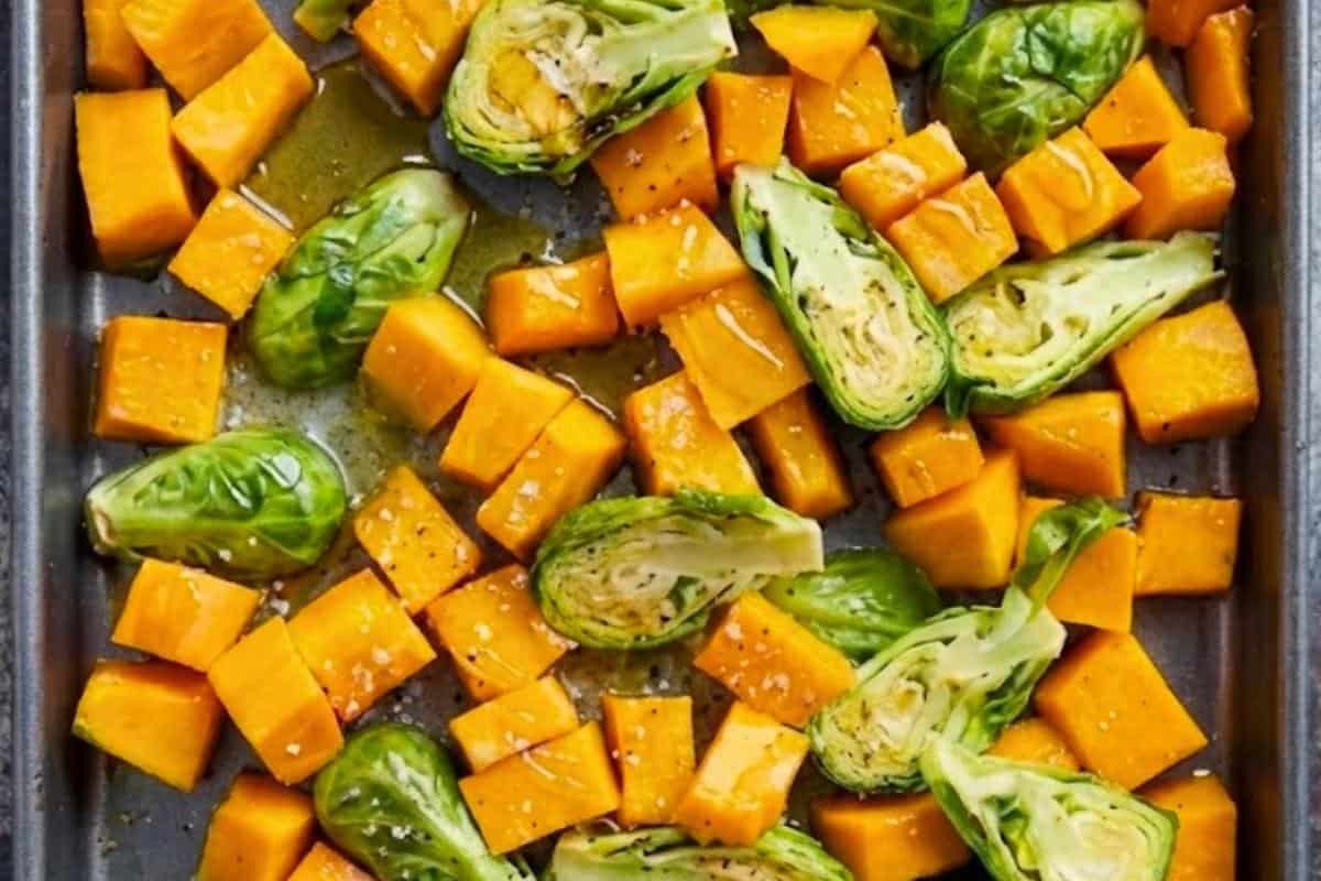 Add the butternut squash and brussels sprouts together on prepared baking sheet. Drizzle with honey and melted butter (or olive oil), season with salt. Toss to evenly coat.