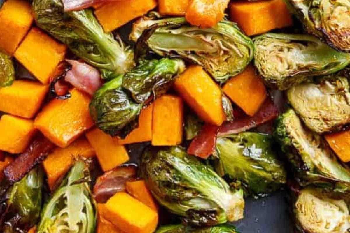 Pan fry the bacon until crisp, then stir it through the roasted squash and sprouts
