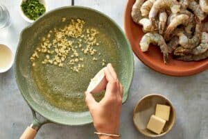 Butter being melted while garlic is cooked