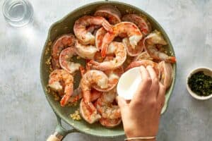 adding remainder butter into the cooked shrimp