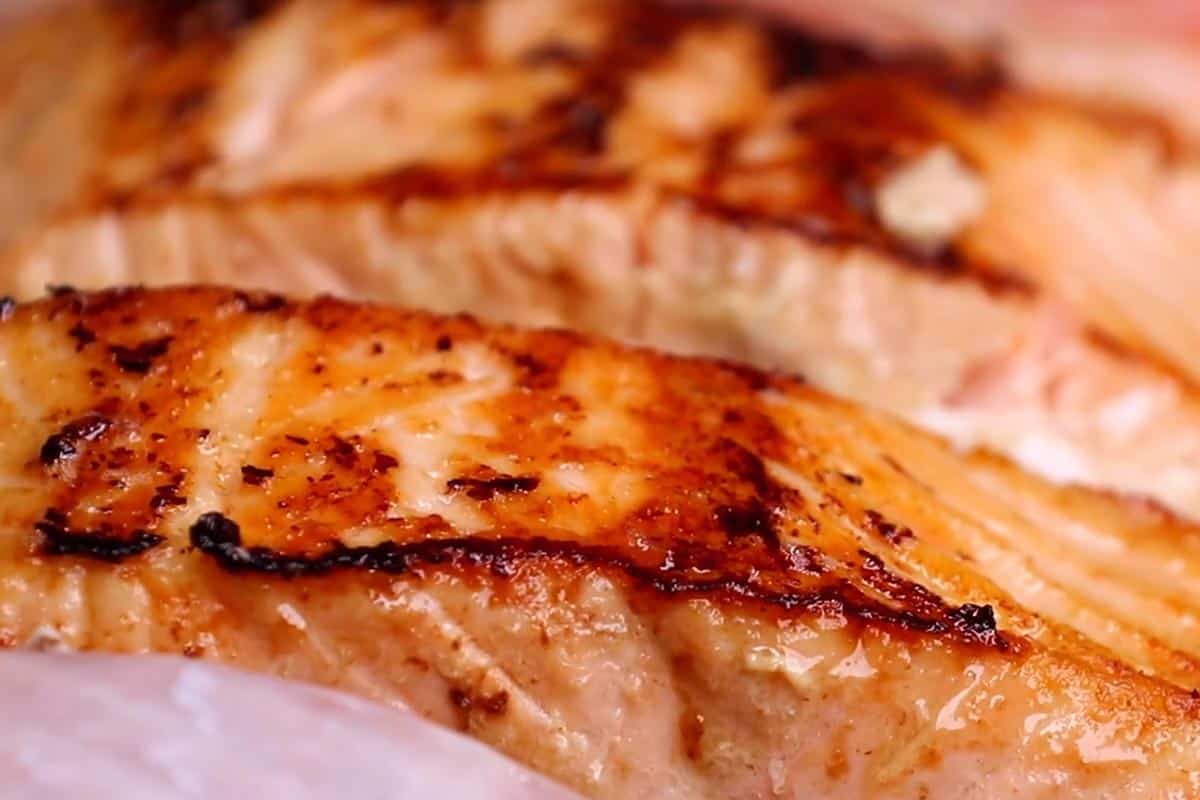 Searing the salmon until golden.