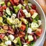 Yum Avocado Greek Salad with a Greek Salad Dressing in a bowl