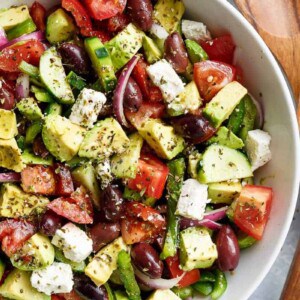 Yum Avocado Greek Salad with a Greek Salad Dressing in a bowl
