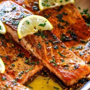 Pan Seared Salmon with Lemon Garlic Butter Sauce with lemon wedges