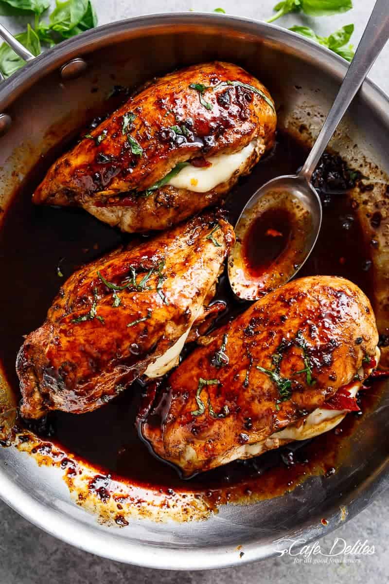Caprese Stuffed Balsamic Chicken with spicy sause is a twist on Caprese, filled with both fresh AND Sun Dried Tomatoes for a flavor packed chicken!