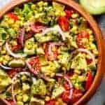 Avocado Corn Tomato Salad with a lime juice dressing in a bowl