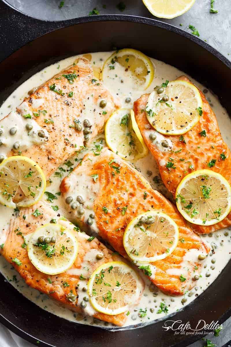Creamy Lemon Garlic Salmon Piccata on a plater is a classy yet easy salmon recipe you\'ve been waiting for, with a delicious creamy lemon caper sauce! 