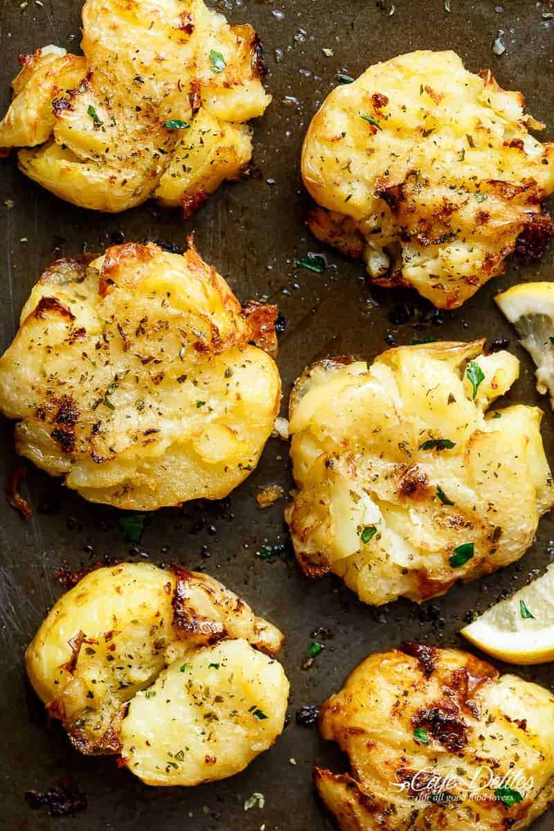 Crispy Greek Lemon Smashed Potatoes are Crispy and golden on the outside, soft and fluffy on the inside kept on a pan