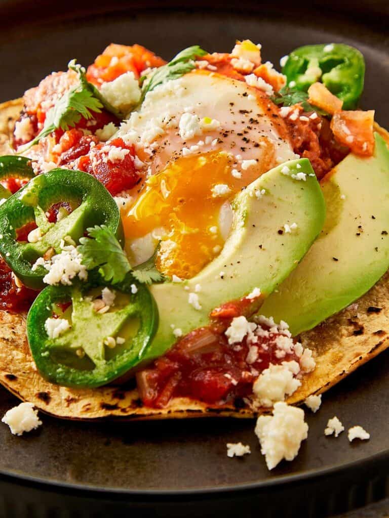 a close up top down view of a fully cooked huevos rancheros