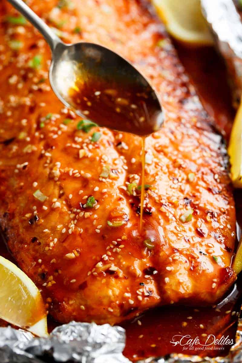 Dressing pouring on Honey Sesame Salmon In Foil is Full of Asian flavours