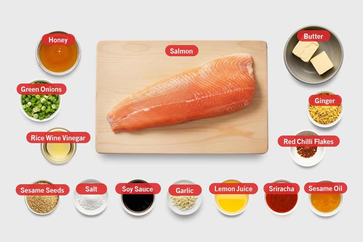 Top shot of ingredients: Honey, salmon, butter, green onions, rice wine vinegar, sesame seeds, salt, soy sauce, garlic, lemon juice, Sriracha, sesame oil, red chilli flakes, and ginger.