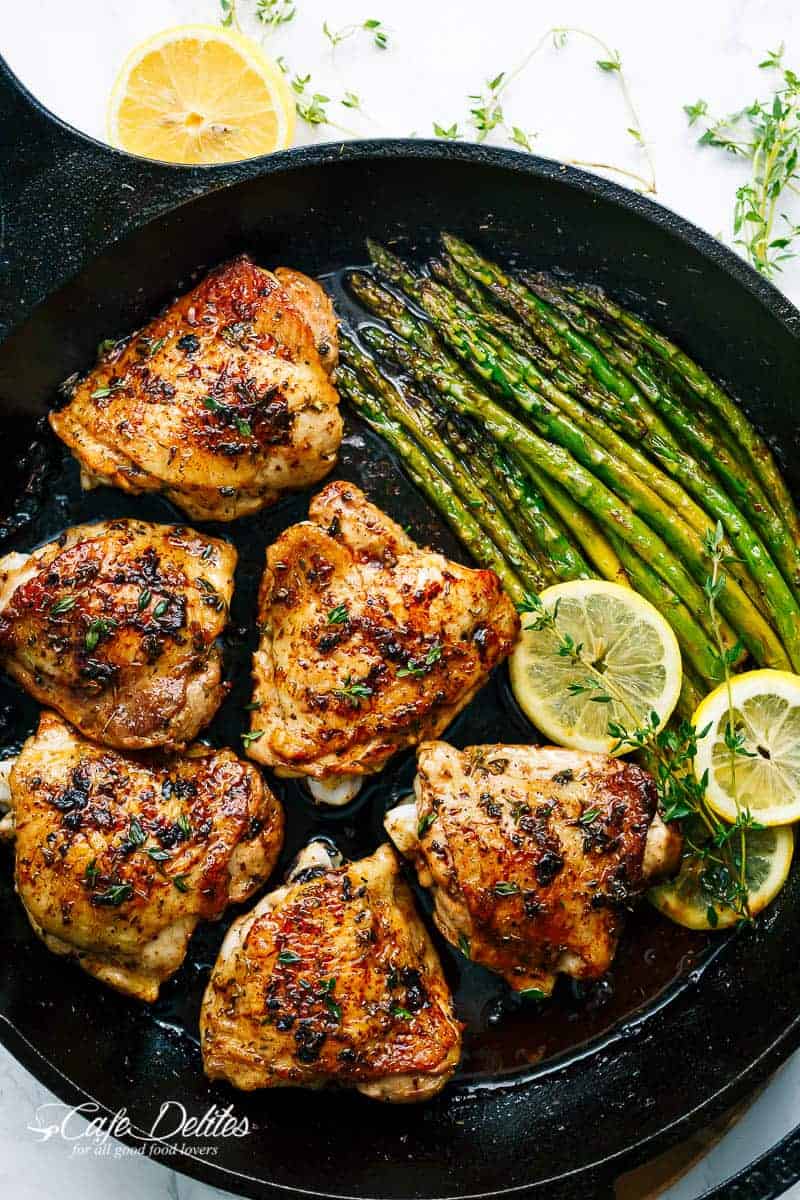Lemon Garlic Butter Chicken Thighs with Asparagus in a pan