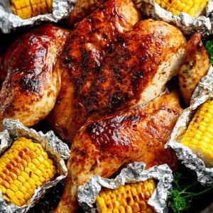 Top view image of Portuguese BBQ Peri Peri Chicken plus the addition of juicy corn cobs in foil packets are charred for added flavour.