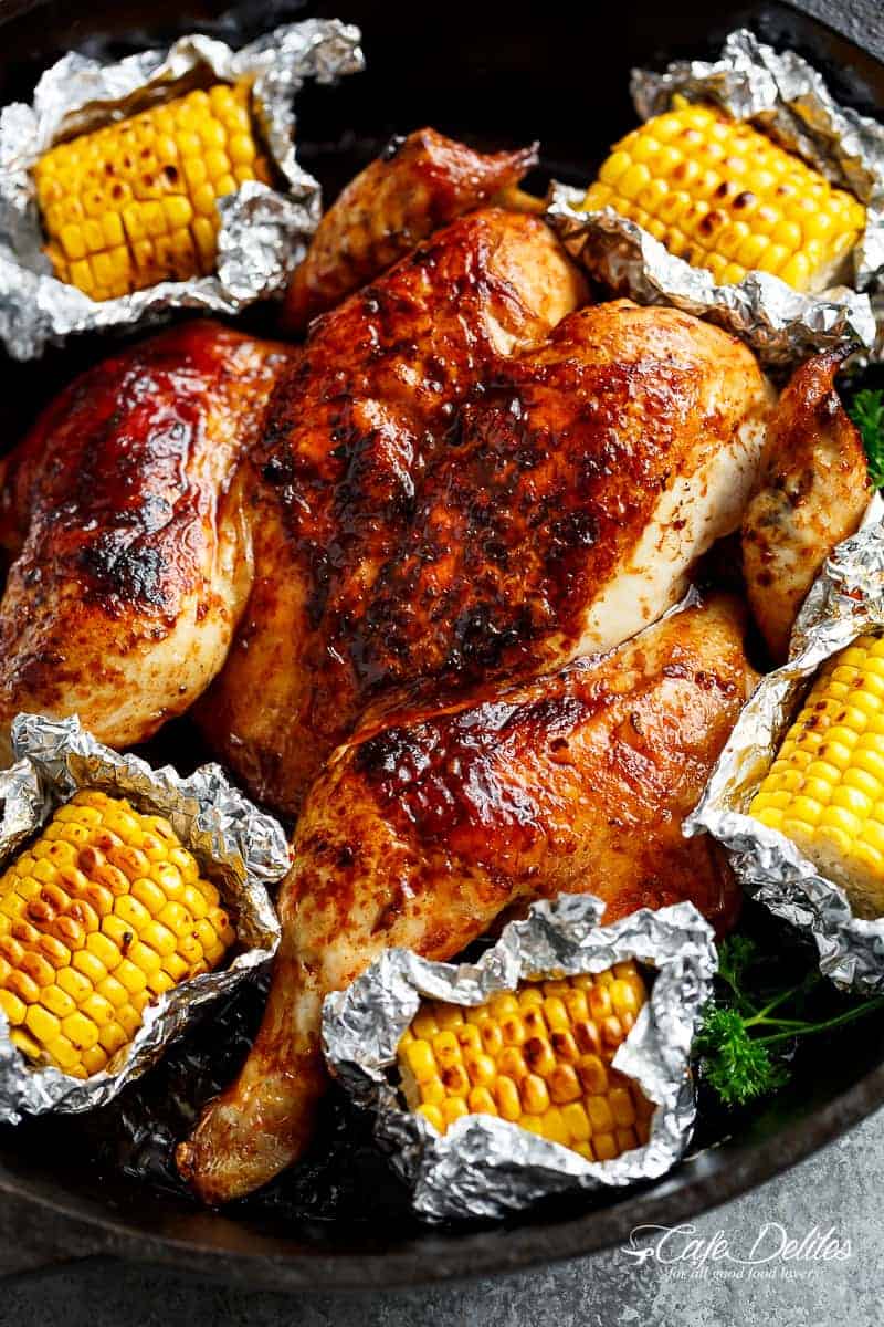 Top view image of Portuguese BBQ Peri Peri Chicken plus the addition of juicy corn cobs in foil packets are charred for added flavour. 