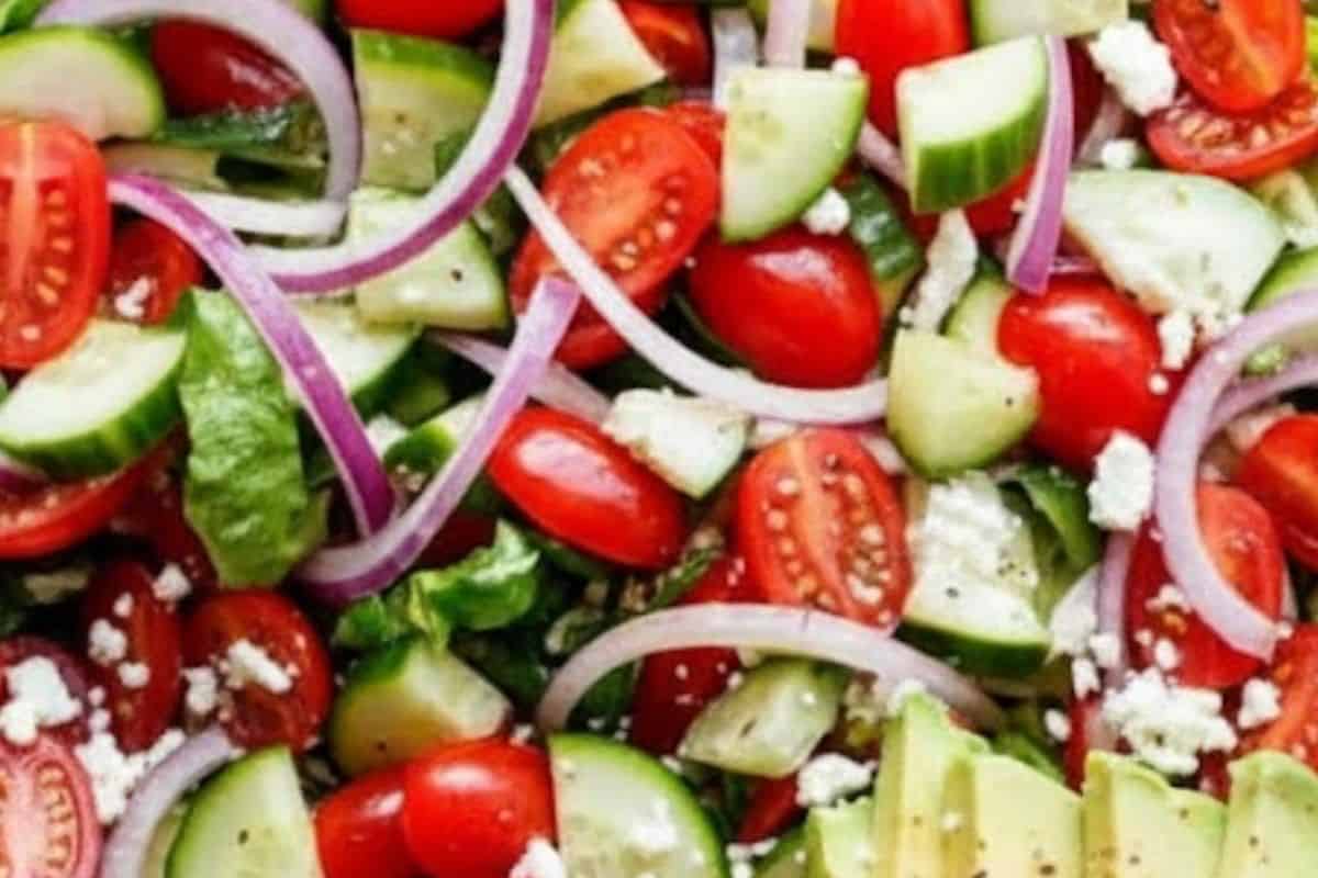 wash and chop the lettuce, cucumber, tomatoes, onion, avocado, and feta, then toss everything together.