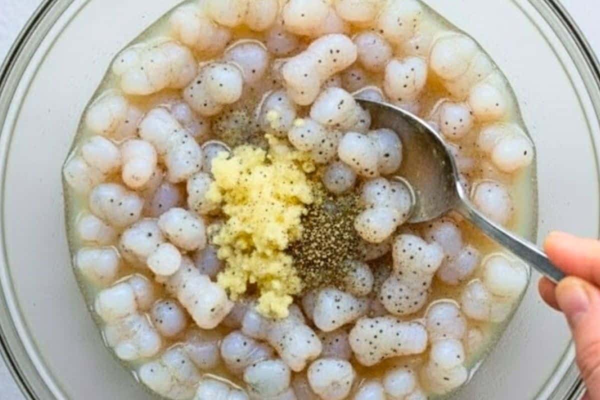 Combine shrimp with lemon or lime juice, garlic, salt, and pepper.