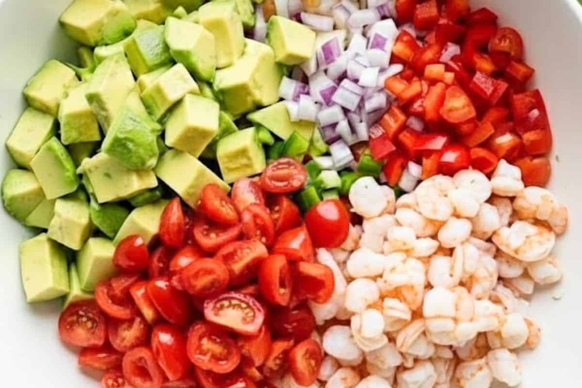 Place the shrimp in a large mixing bowl and add the avocados, red onion, tomatoes, jalapeños, and red pepper
