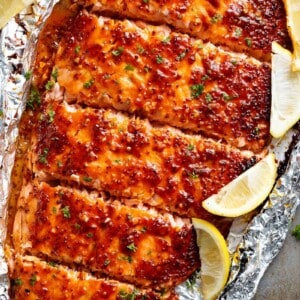 Garlic Butter Honey Mustard Salmon with some lemon wedges In Foil