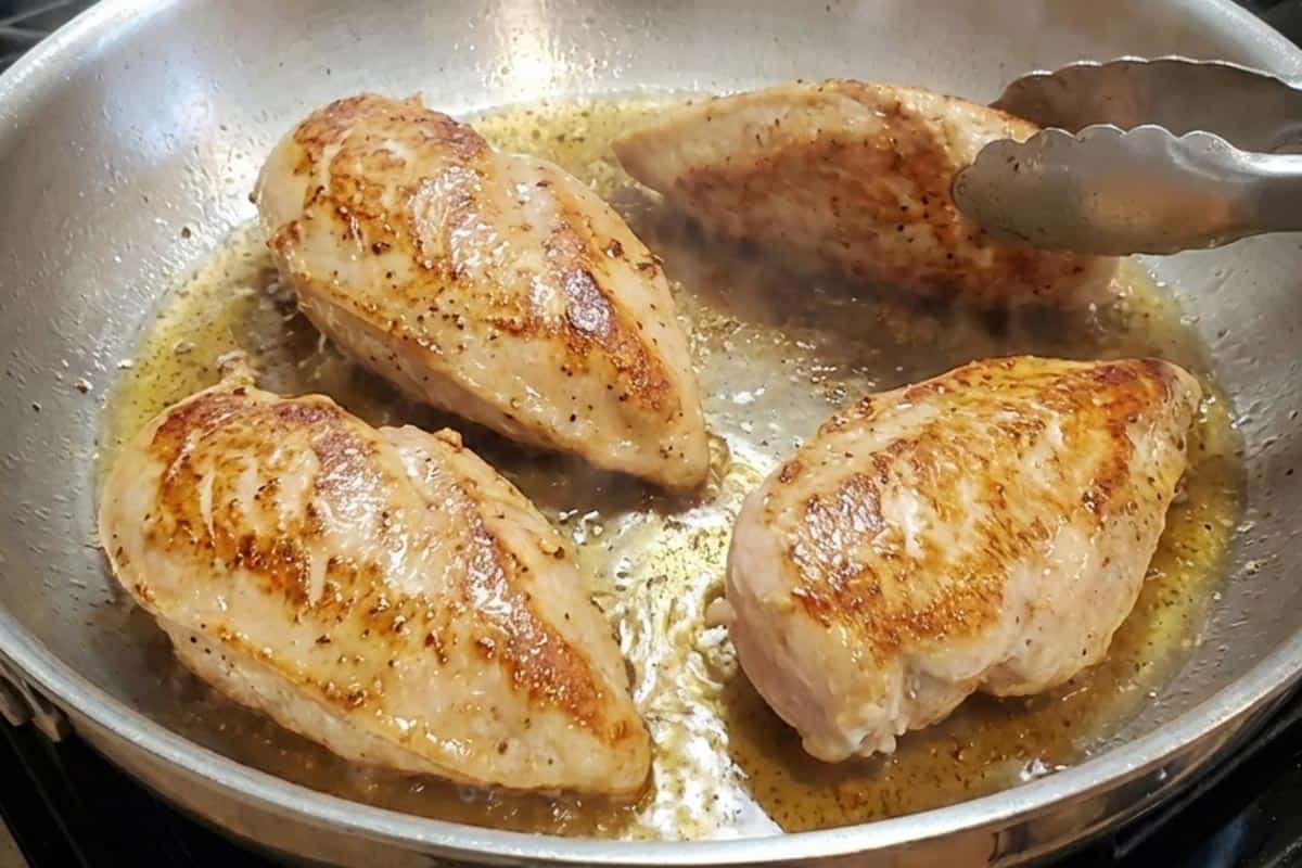 Frying the chicken in the pan.