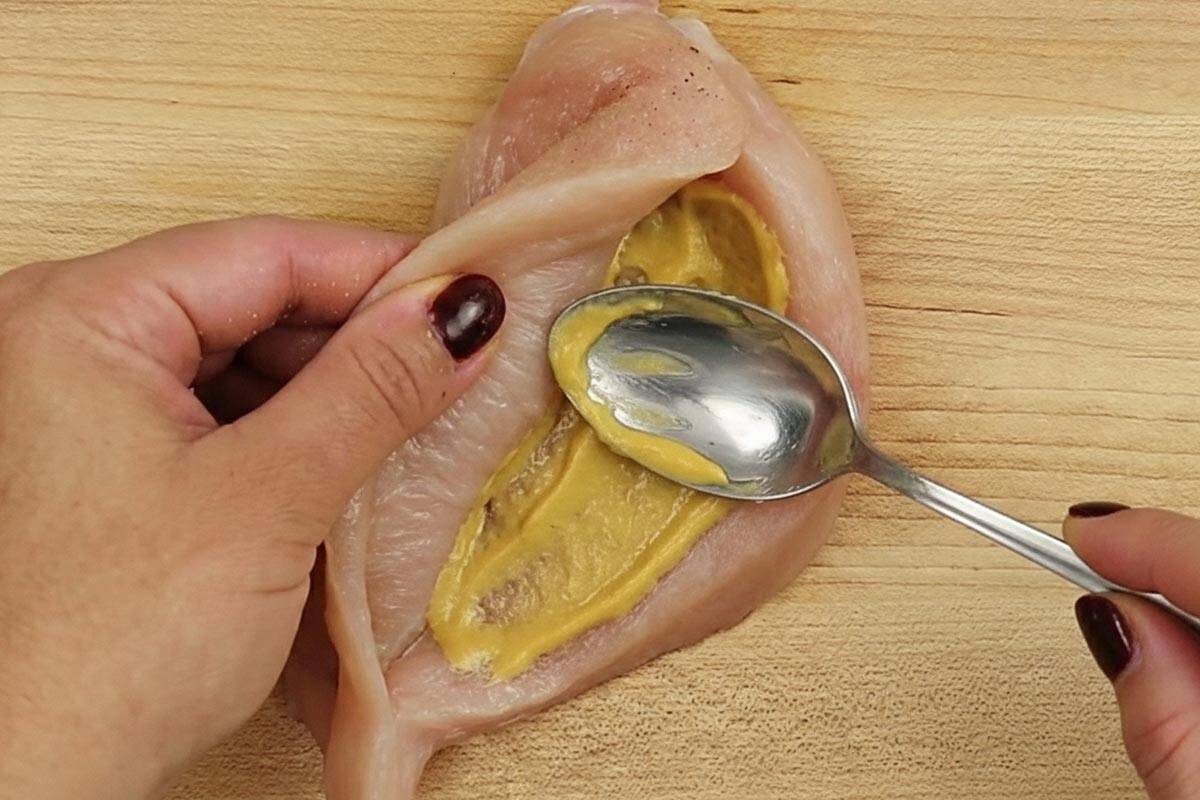 Spreading one teaspoon of mustard in the pocket.