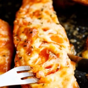 Mozzarella cheese and parmesan top these tender garlic butter smothered sweet potatoes!
