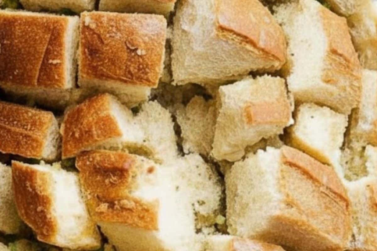 Using a bread knife, slice loaf in a criss-cross pattern about 1 inch wide, careful not to cut all the way through. Place loaf on the baking tray.
