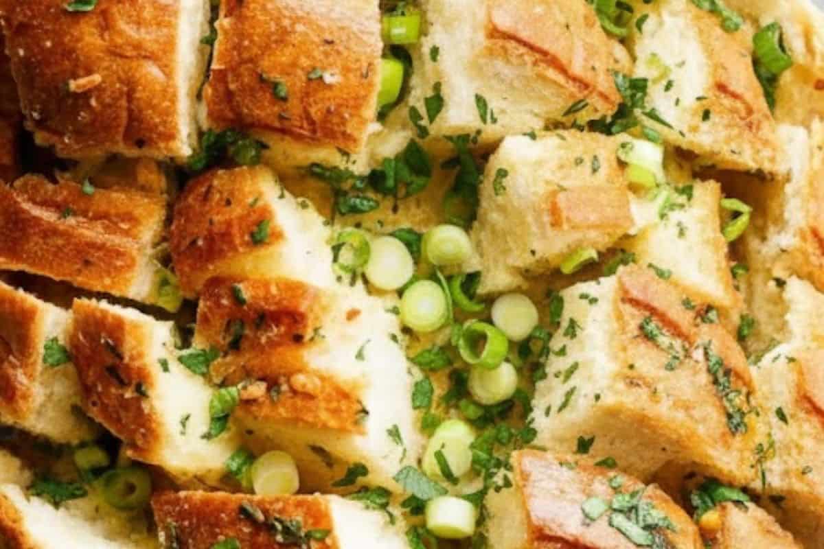 Gently spoon the garlic butter mixture into each cut of the bread
