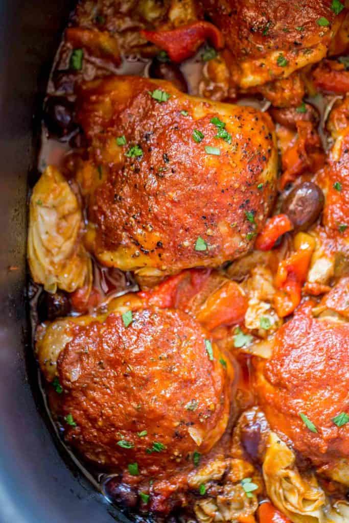 Slow Cooker Mediterranean Chicken with artichoke hearts, olives and roasted red peppers in a briny, herby tomato sauce is tender and flavorful with just five minutes of prep work! Cooked Chicken with olives and artichokes in Slow cooker .