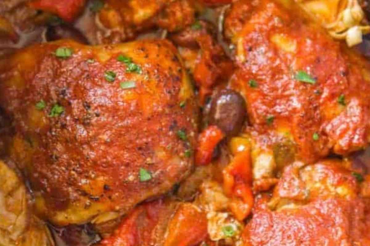 Scatter the remaining red peppers, artichoke hearts, and olives around the chicken, then pour the blended sauce over the chicken.