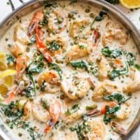 Garlic butter shrimp coated in a rustic creamy garlic parmesan sauce with a hint of lemon, capers and spinach in a pan