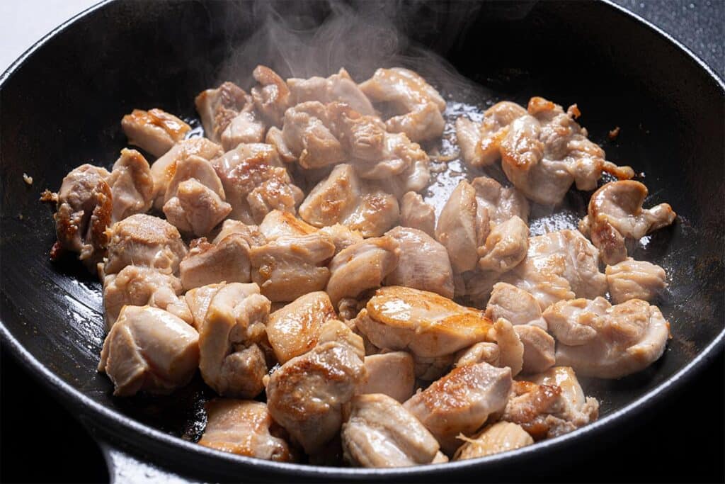Chicken being cooked in a pan