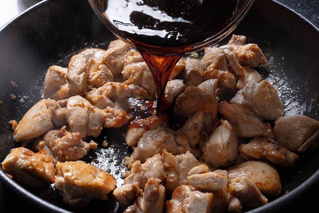 Pouring the sauce in the chicken