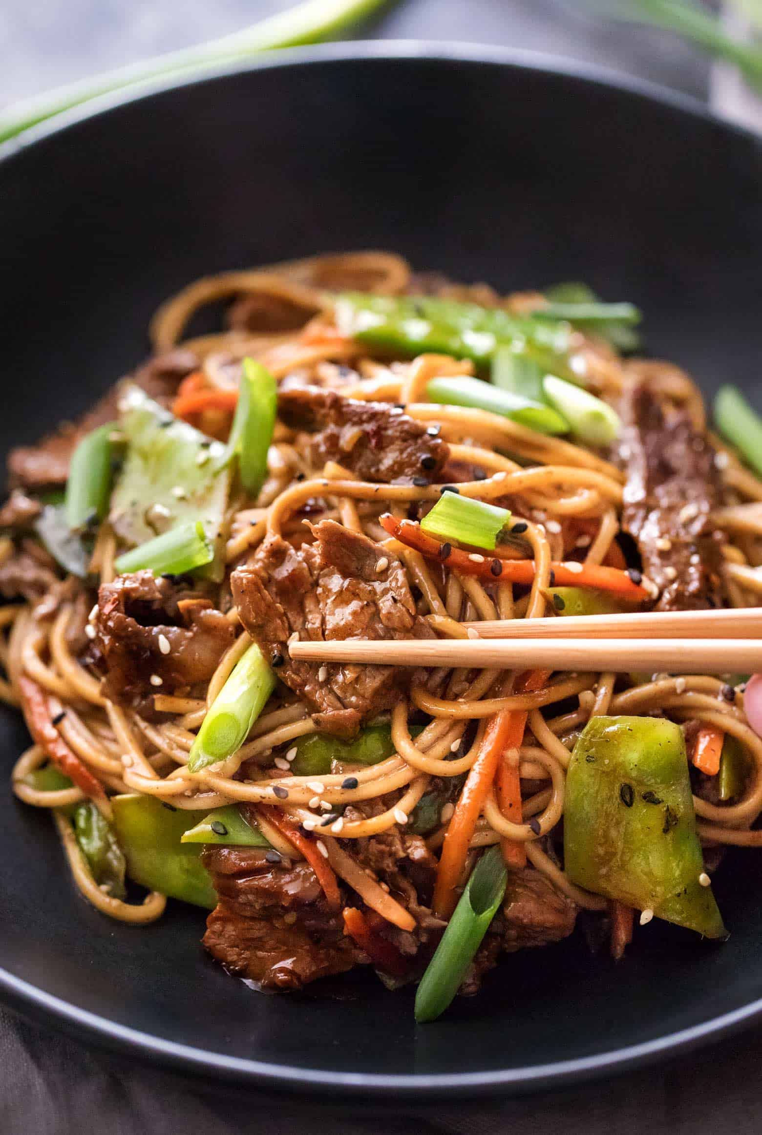 Beef stir fry | cafedelites.com Beef stir fry noodles in bowl with chopsticks