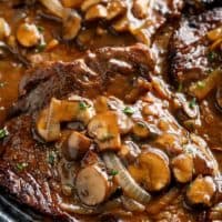 Ribeye Steaks With Mushroom Gravy in a pan