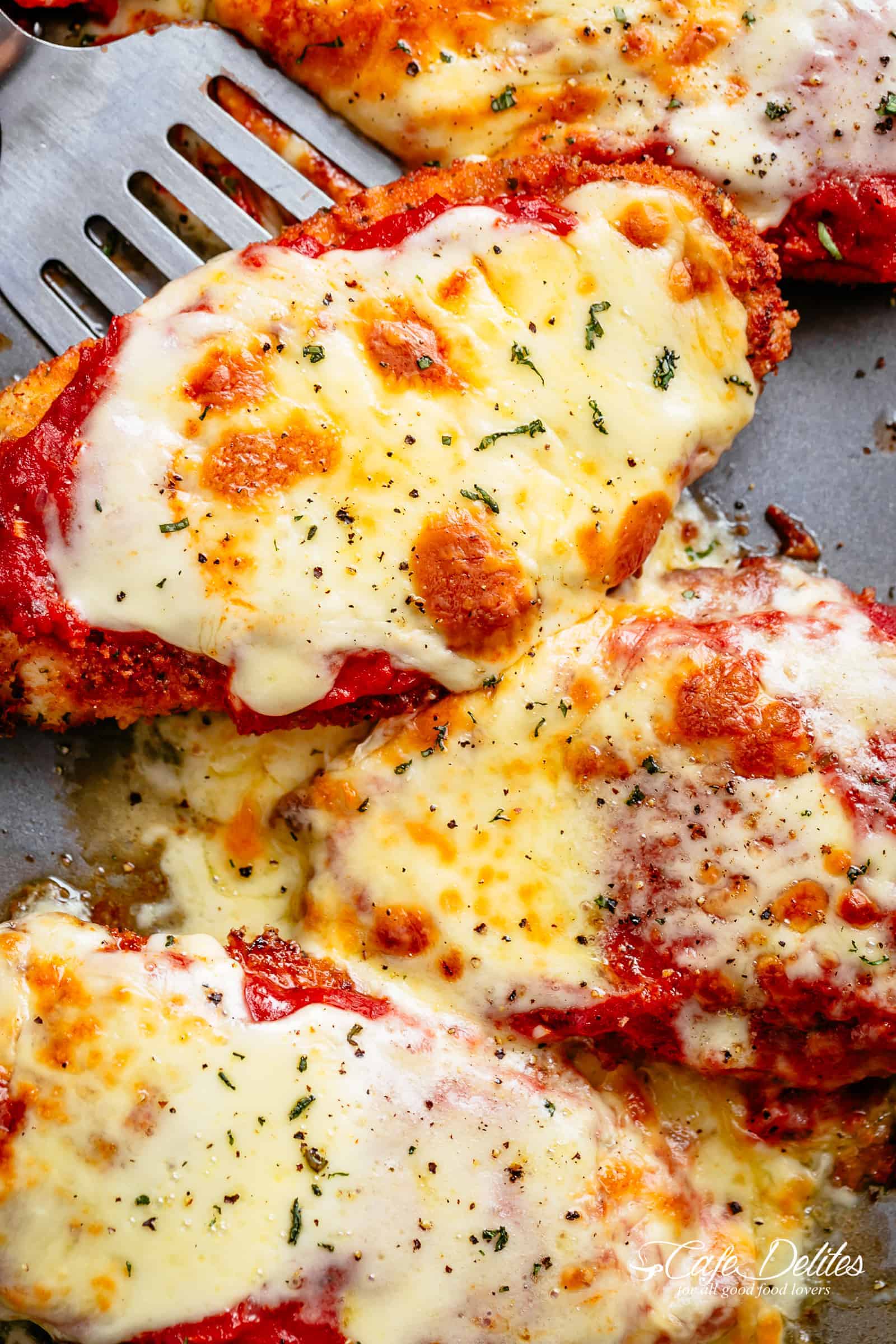 The Best Chicken Parmesan with a deliciously crispy breadcrumb coating, smothered in a rich homemade tomato sauce and melted mozzarella cheese! This is here best Chicken Parmesan you will ever make! Simple to make and worth every minute. If you love a crispy crumb coating vs soggy crumb, look no further!